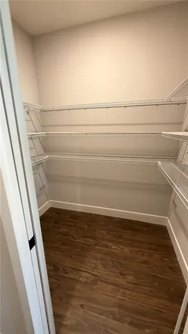 a view of an empty room and wooden floor