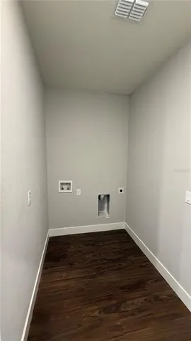 an empty room with wooden floor and closet