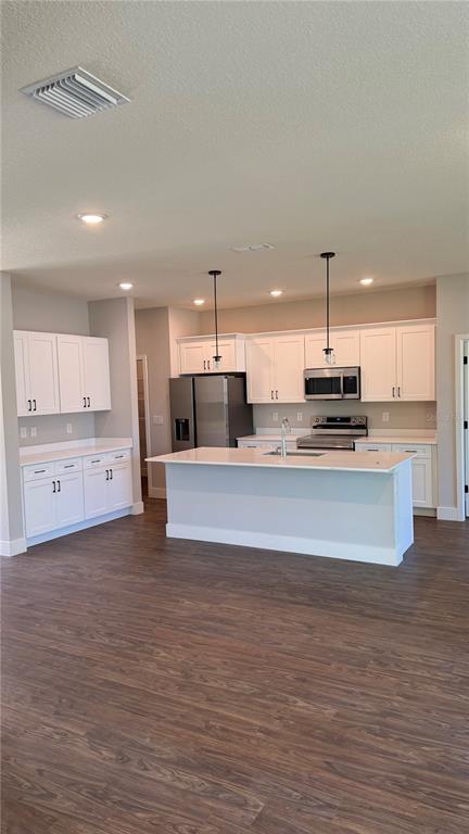 76 Boston Lane Palm Coast, FL 32137 - Photo 3 of 15 a large kitchen with stainless steel appliances a large counter top a stove and a refrigerator