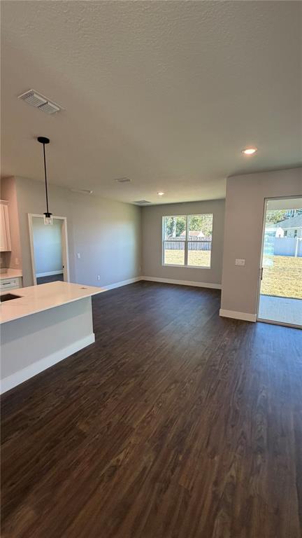 76 Boston Lane Palm Coast, FL 32137 - Photo 4 of 15 a view of an empty room with wooden floor and a window