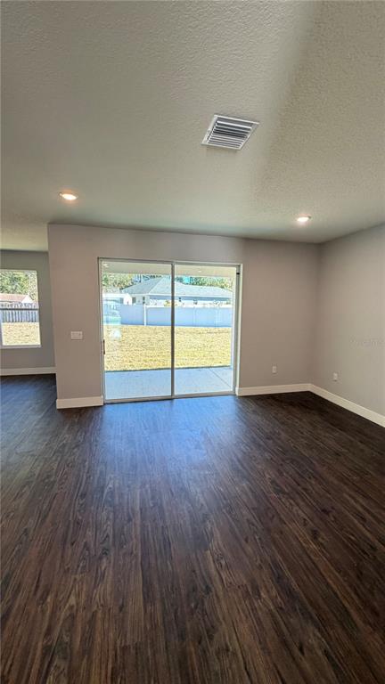 76 Boston Lane Palm Coast, FL 32137 - Photo 5 of 15 an empty room with wooden floor and windows