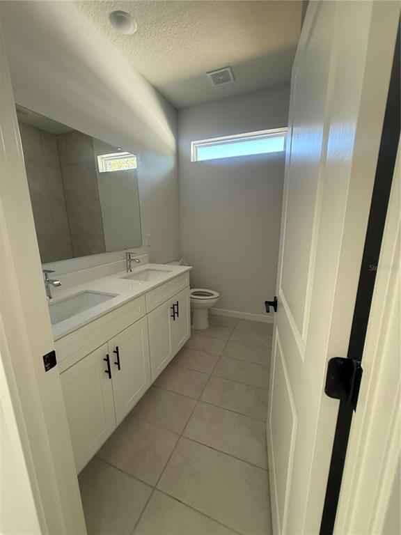 76 Boston Lane Palm Coast, FL 32137 - Photo 7 of 15 a bathroom with a double vanity sink and a mirror