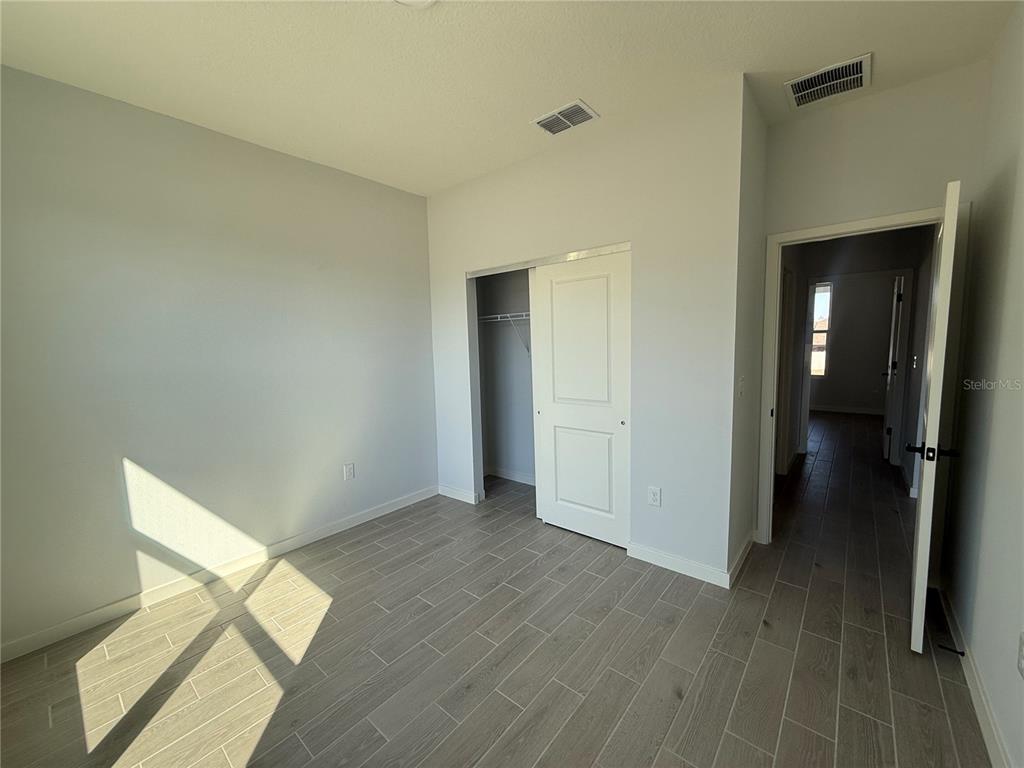 76 Boston Lane Palm Coast, FL 32137 - Photo 10 of 15 a view of empty room with wooden floor
