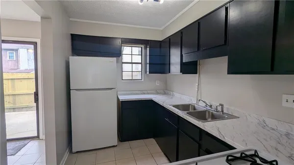a kitchen with a sink appliances and cabinets