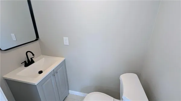 a bathroom with a sink mirror and toilet