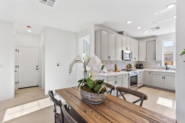 a kitchen with white cabinets and counter space