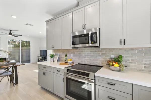 a kitchen with stainless steel appliances white cabinets and a sink