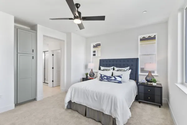 a bedroom with a bed and ceiling fan
