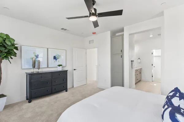 a bedroom with a bed and a dresser