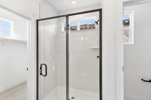a bathroom with a glass shower door