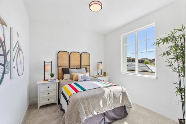 a bedroom with a bed and a large window