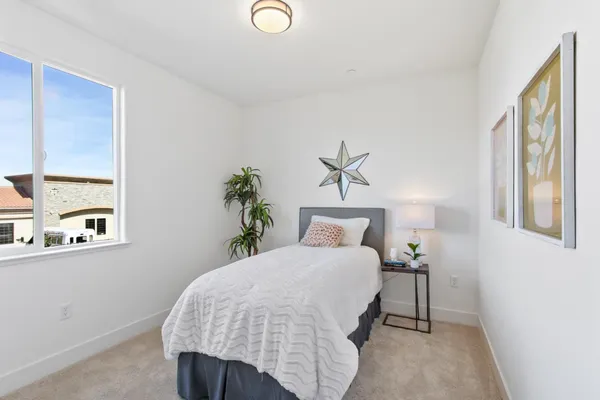 a bedroom with a bed and window