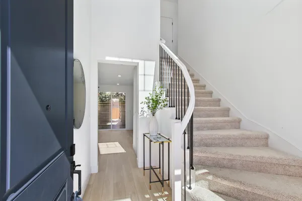 a view of entryway and hall with wooden floor