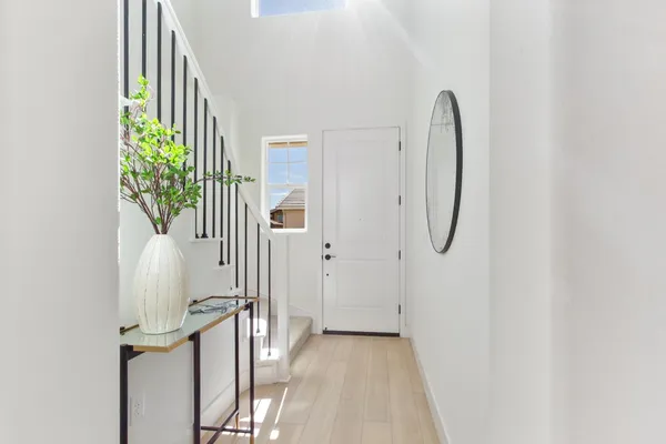 a view of a room with wooden floor and entryway