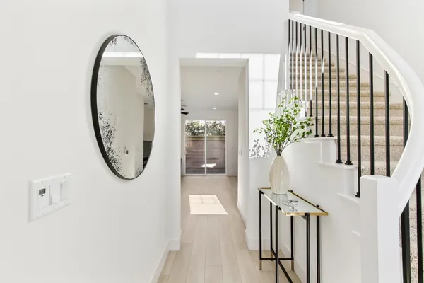 an entryway with a potted plant on brick wall