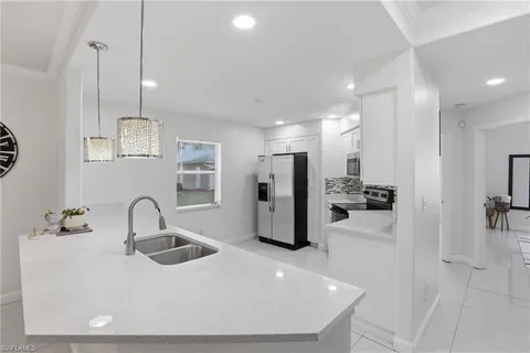 a kitchen with refrigerator and sink