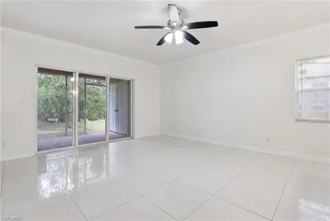 a view of a livingroom with a ceiling fan and window