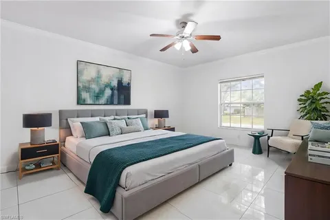 an empty room with windows and chandelier fan