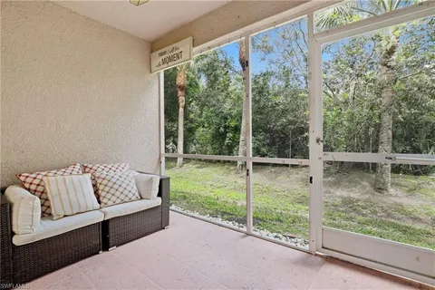a living room with furniture and a glass door shower