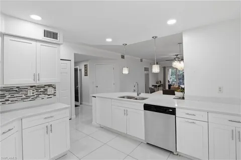 a kitchen with granite countertop a stove and a sink