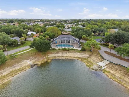 an aerial view of a house with a yard and lake view