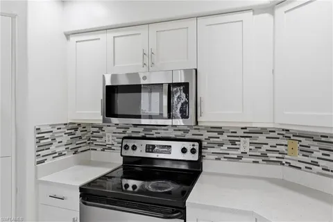 a kitchen with stainless steel appliances a refrigerator stove and microwave