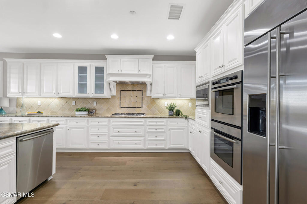 3421 Deep Waters Court Simi Valley, CA 93065 - Photo 28 of 74 a kitchen with stainless steel appliances granite countertop a refrigerator and a stove