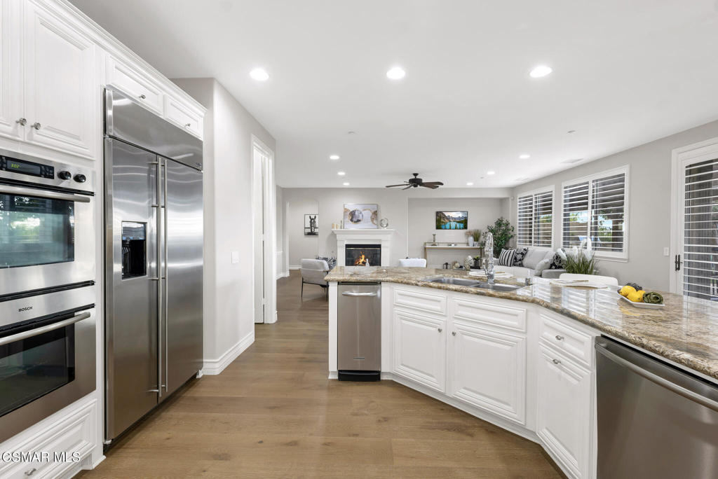 3421 Deep Waters Court Simi Valley, CA 93065 - Photo 30 of 74 a kitchen with a sink stainless steel appliances and cabinets