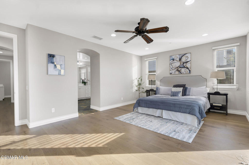 3421 Deep Waters Court Simi Valley, CA 93065 - Photo 37 of 74 a spacious bedroom with a large bed and a chandelier