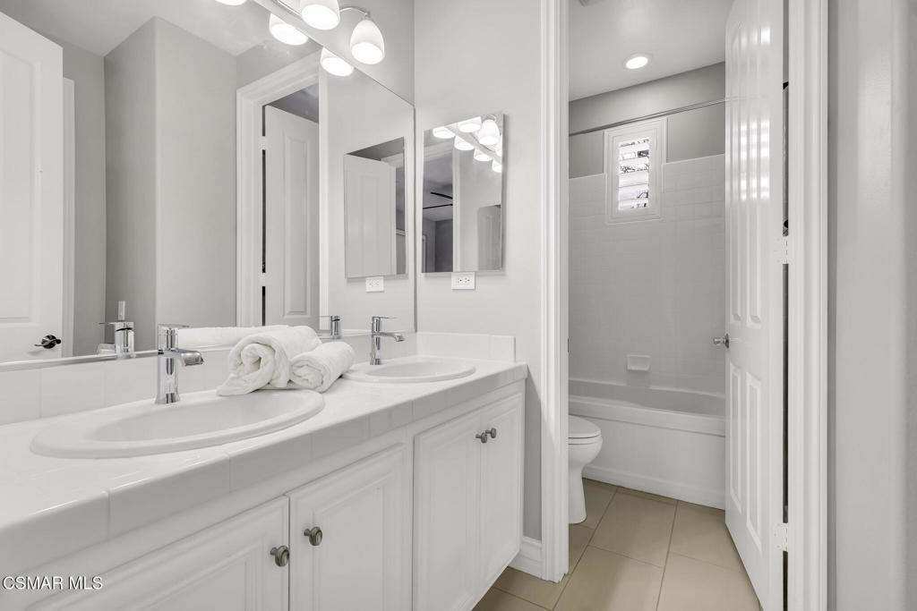 3421 Deep Waters Court Simi Valley, CA 93065 - Photo 52 of 74 a bathroom with a double vanity sink mirror and bathtub