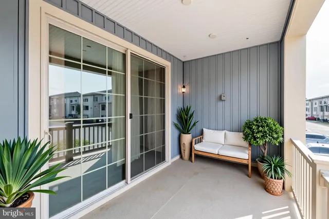 a living room with furniture potted plant and a window
