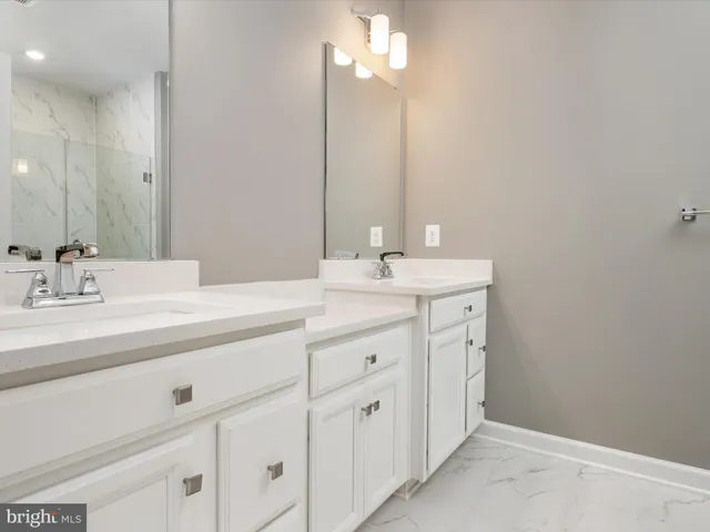 a bathroom with a sink vanity and a mirror
