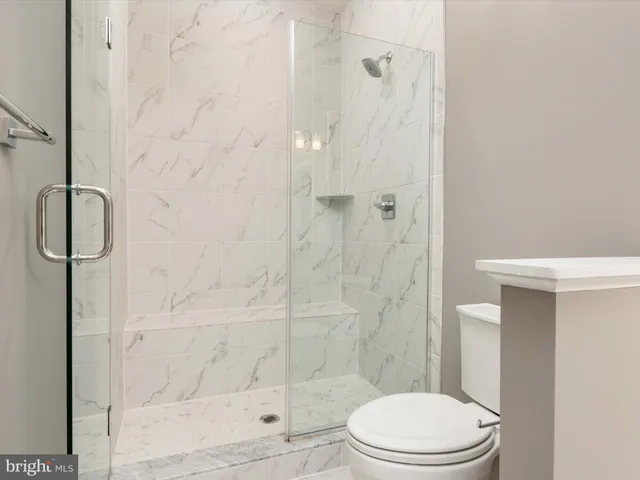 a toilet sitting next to a bathroom