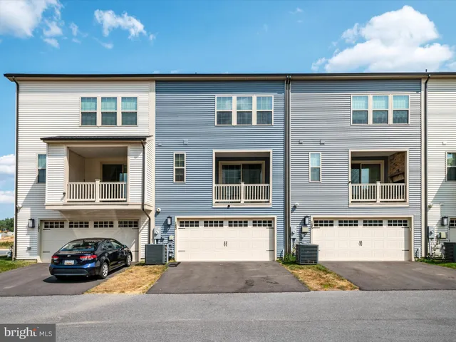 a black car parked in front of a house