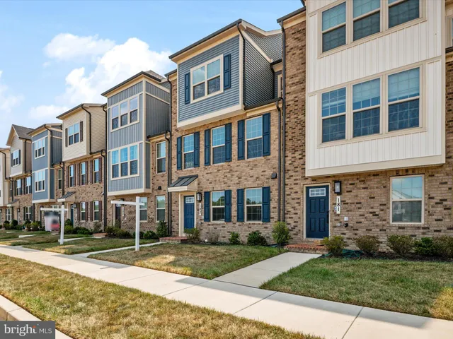 a view of a brick building next to a yard