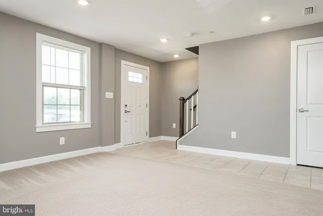 an empty room with windows and closet
