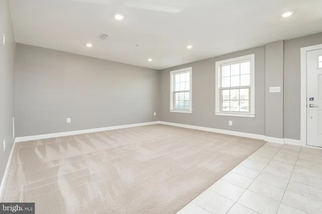 an empty room with windows and entrance