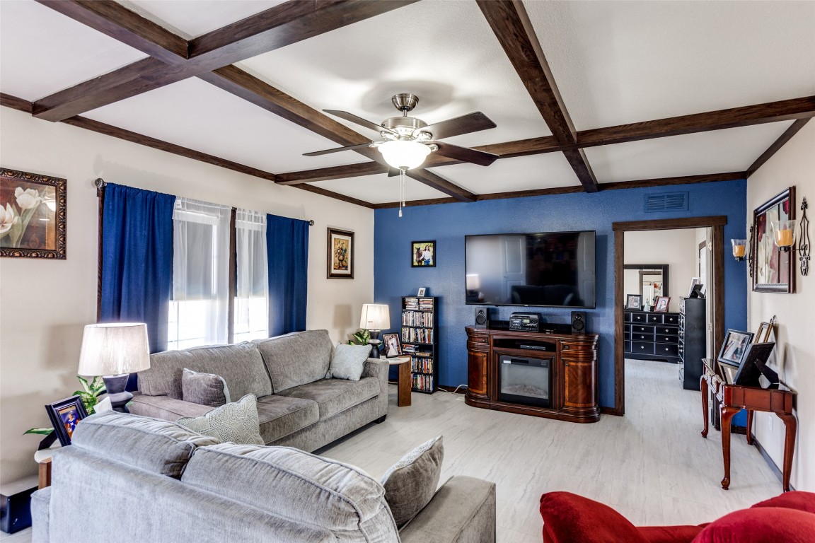 7905 Plato Path, Unit 111 Austin, TX 78724 - Photo 2 of 12 a living room with furniture a flat screen tv and a ceiling fan