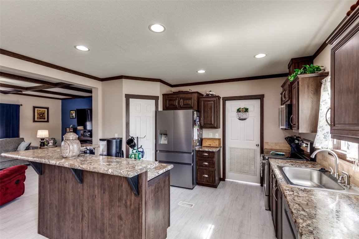 7905 Plato Path, Unit 111 Austin, TX 78724 - Photo 5 of 12 a kitchen with granite countertop a sink stove and refrigerator