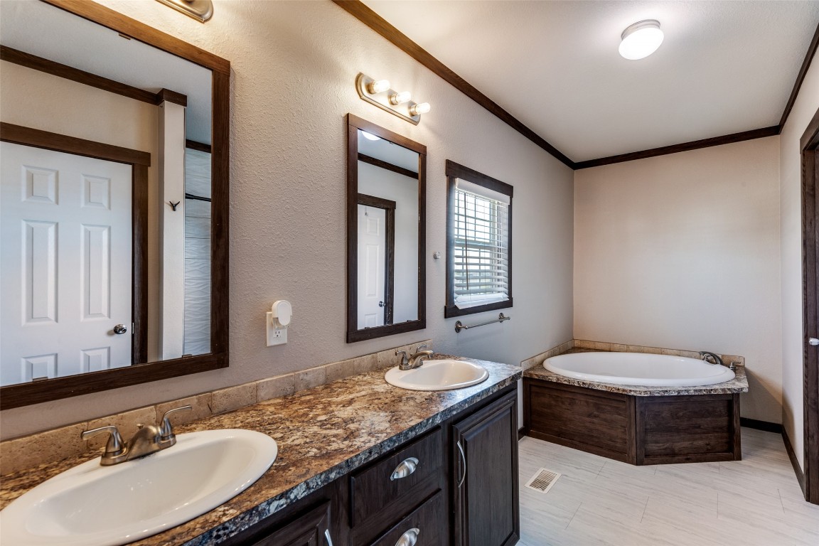 7905 Plato Path, Unit 111 Austin, TX 78724 - Photo 8 of 12 a bathroom with a granite countertop sink and a mirror