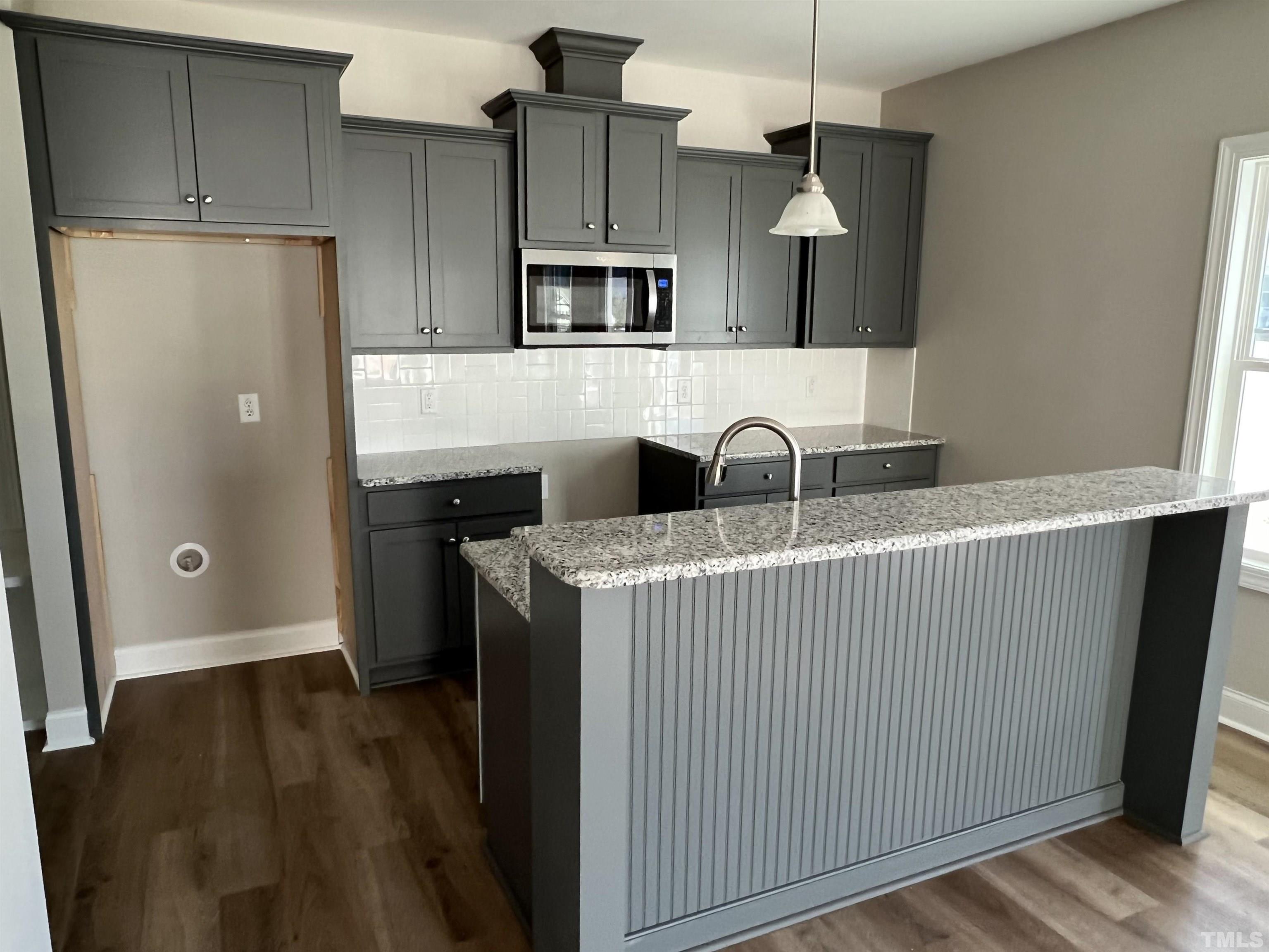 80 Unique Place Garner, NC 27529 - Photo 11 of 28 a kitchen with a refrigerator sink and cabinets