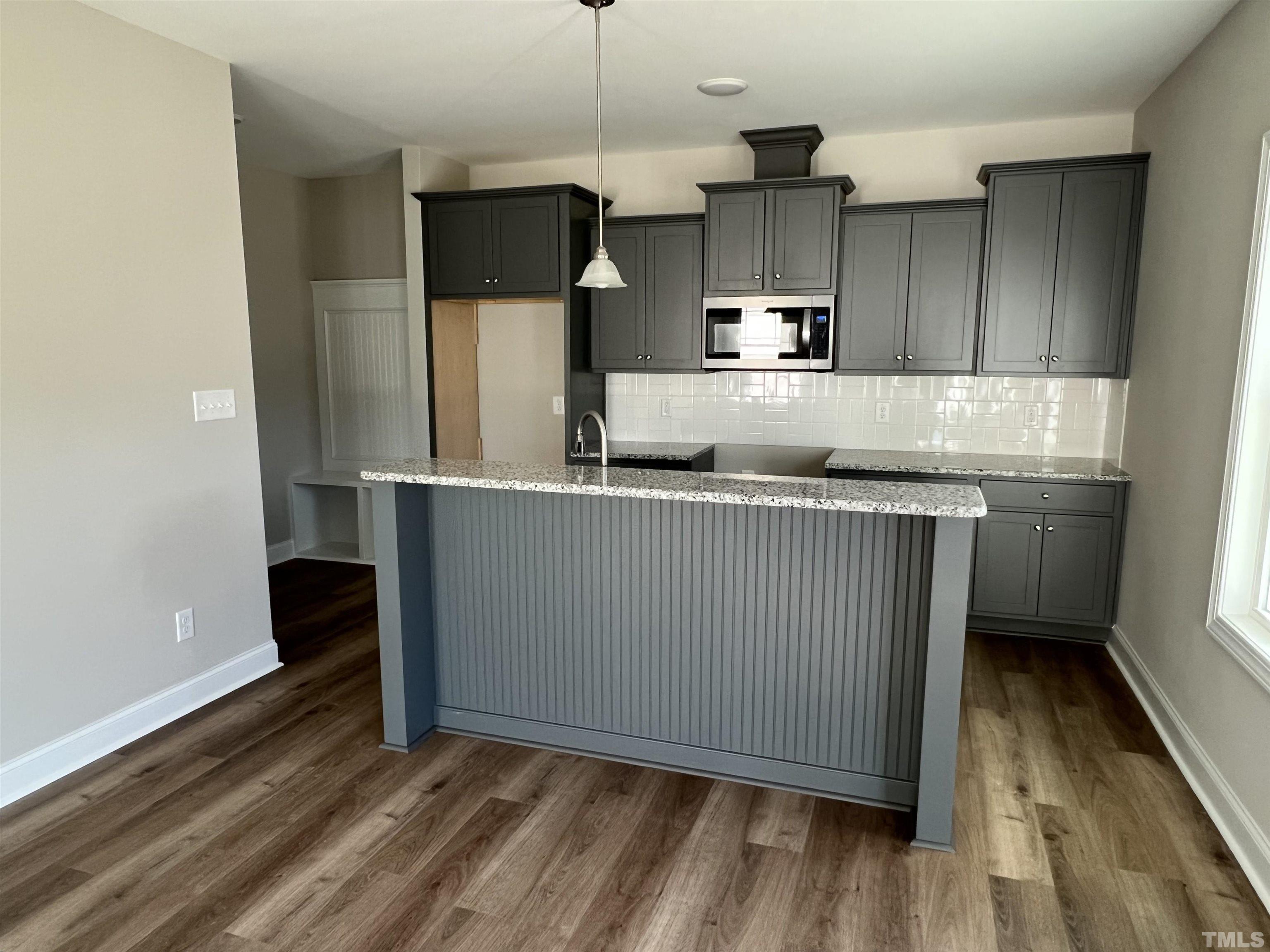 80 Unique Place Garner, NC 27529 - Photo 12 of 28 a kitchen with stainless steel appliances granite countertop a sink a stove and a refrigerator