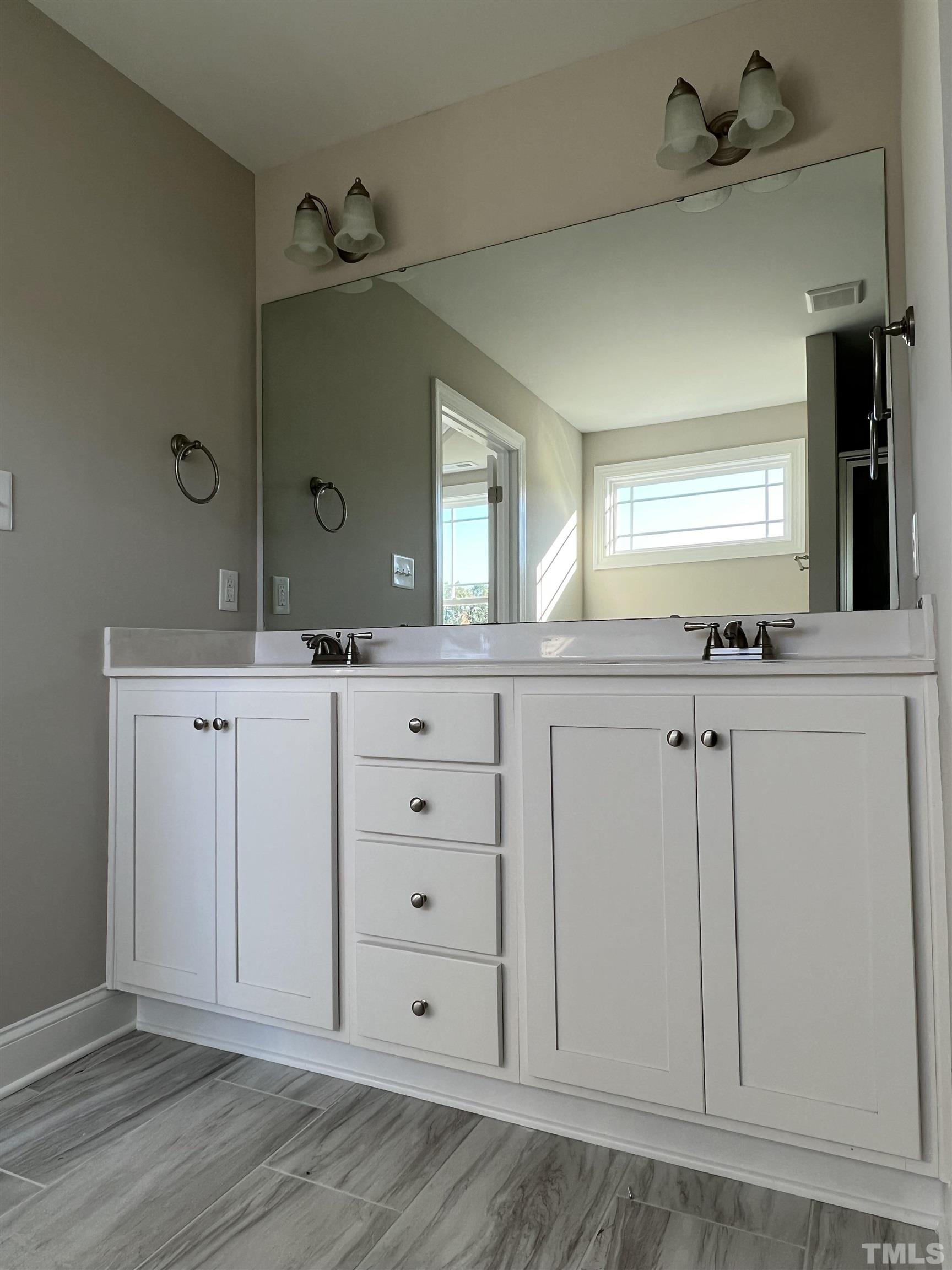 80 Unique Place Garner, NC 27529 - Photo 16 of 28 a bathroom with a sink vanity and mirror