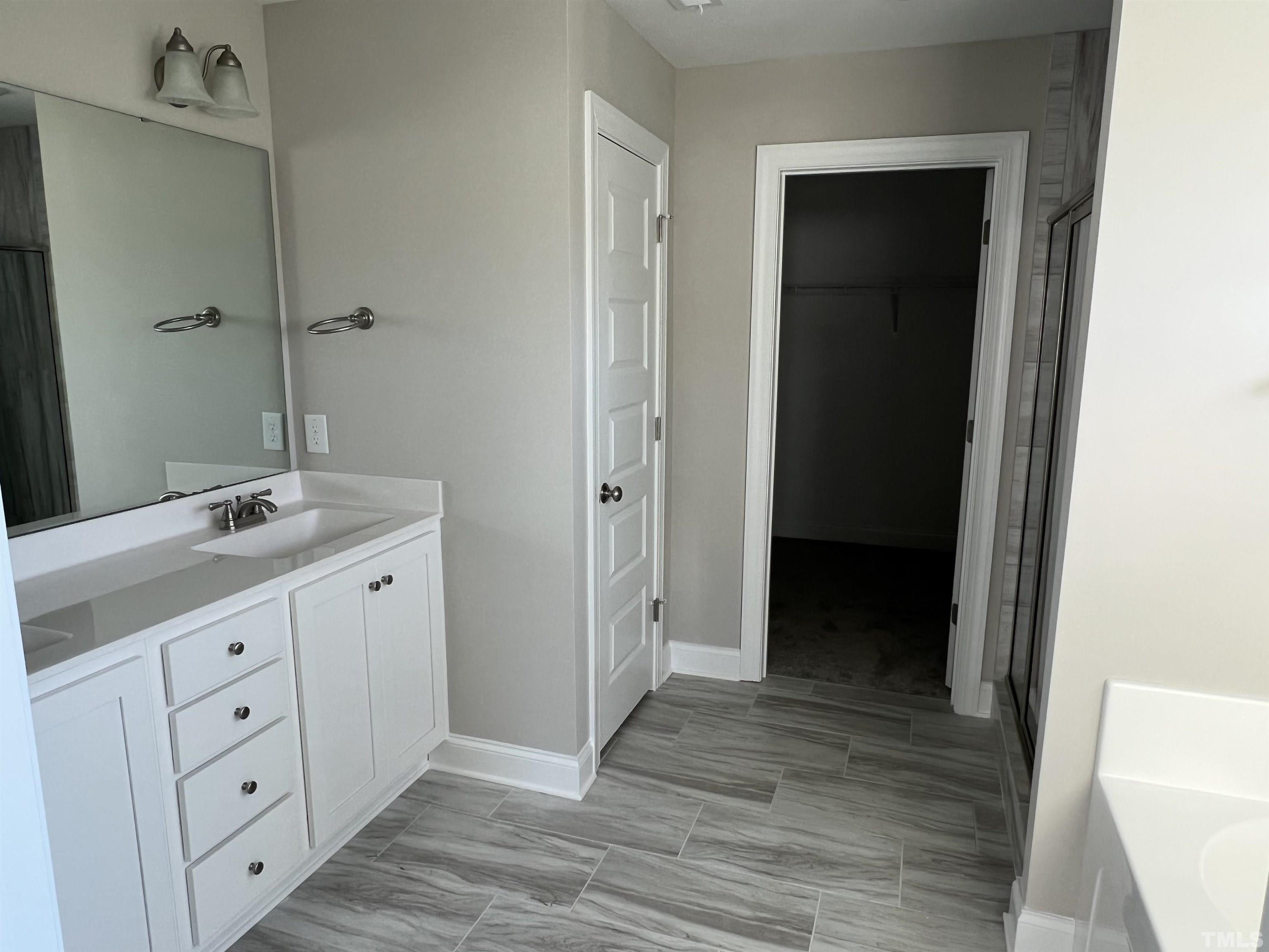 80 Unique Place Garner, NC 27529 - Photo 17 of 28 a bathroom with a double vanity sink and mirror