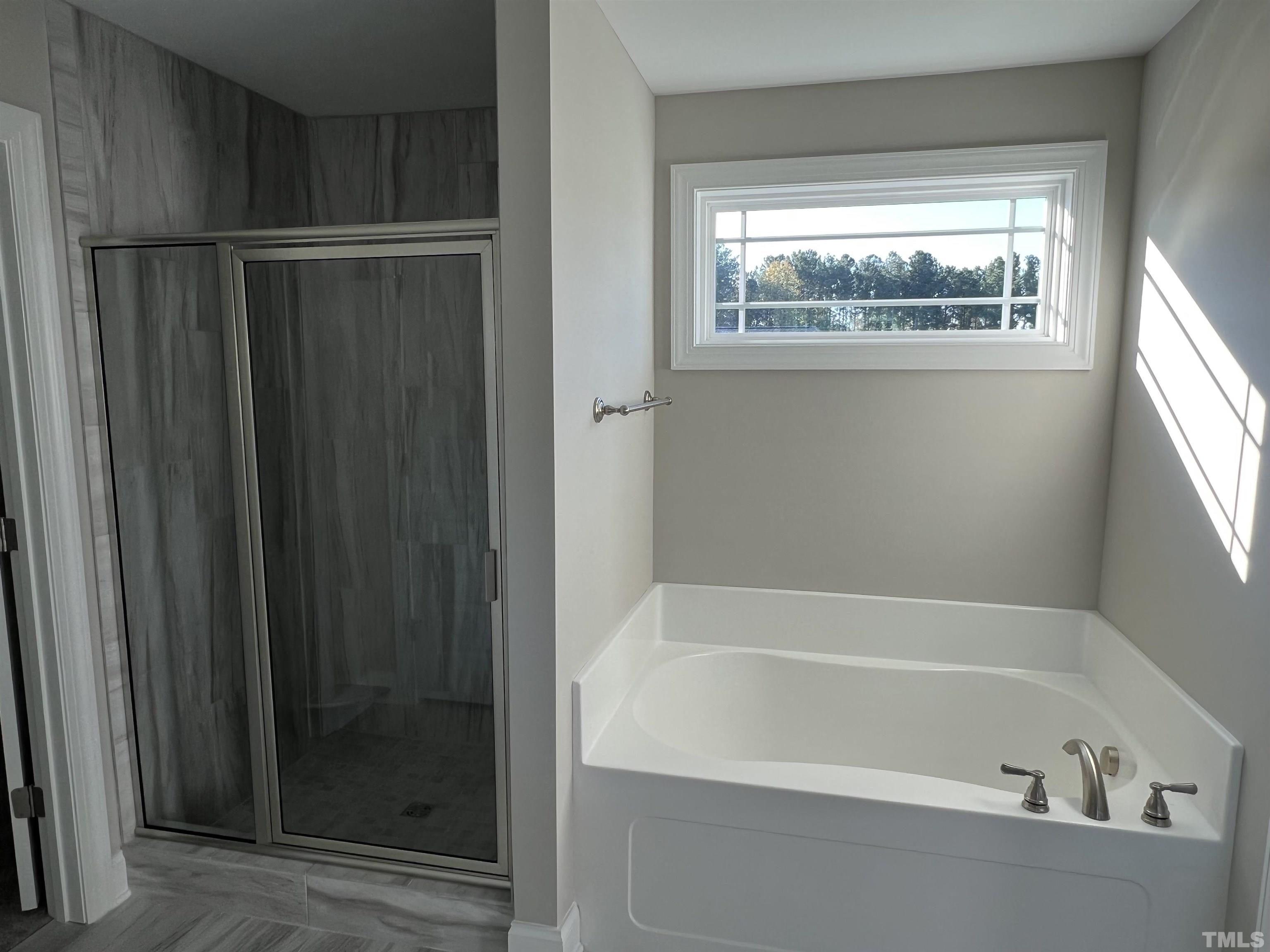 80 Unique Place Garner, NC 27529 - Photo 18 of 28 a bathroom with a bathtub and a window