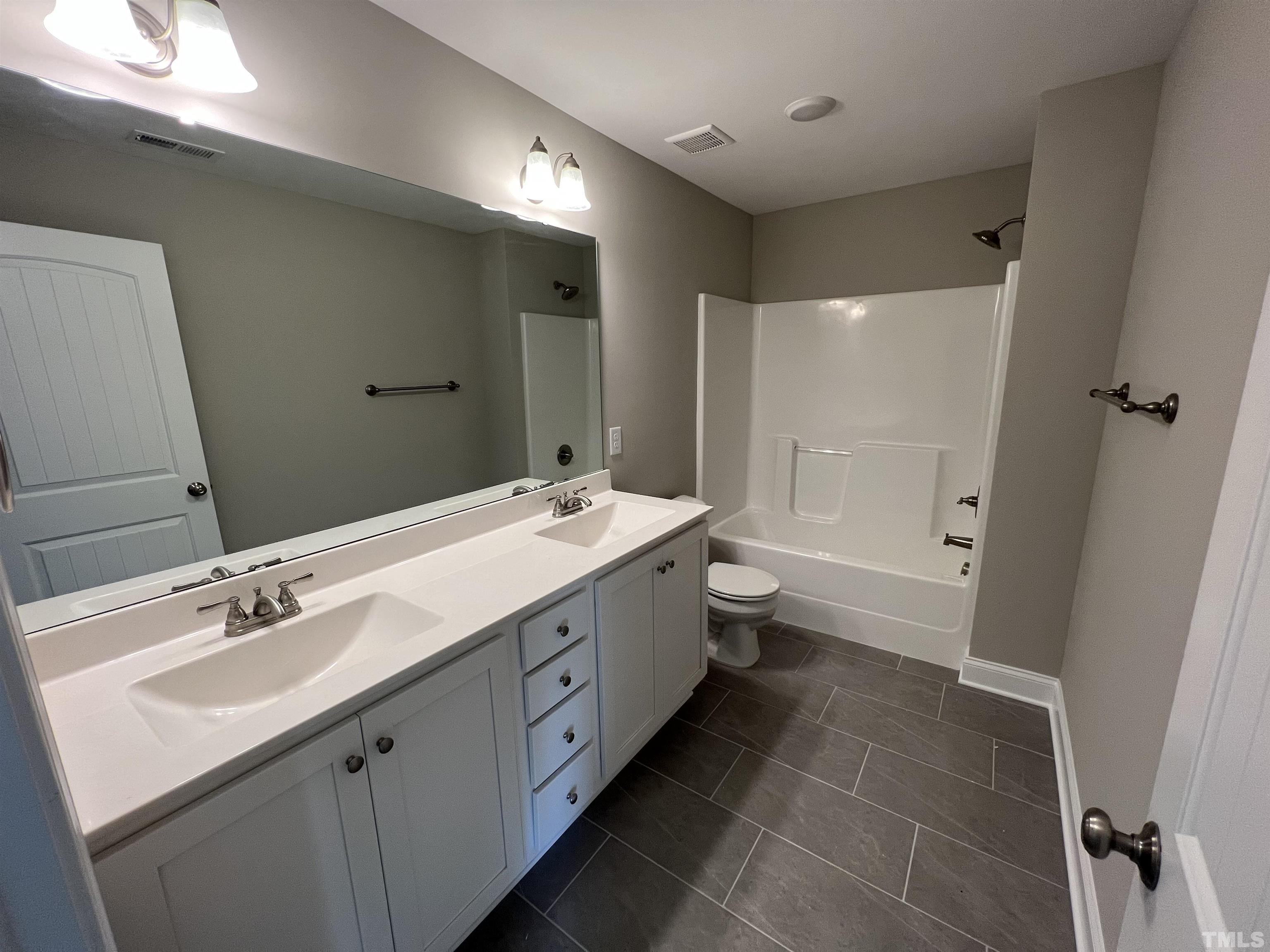 80 Unique Place Garner, NC 27529 - Photo 26 of 28 a bathroom with a double vanity sink mirror and toilet