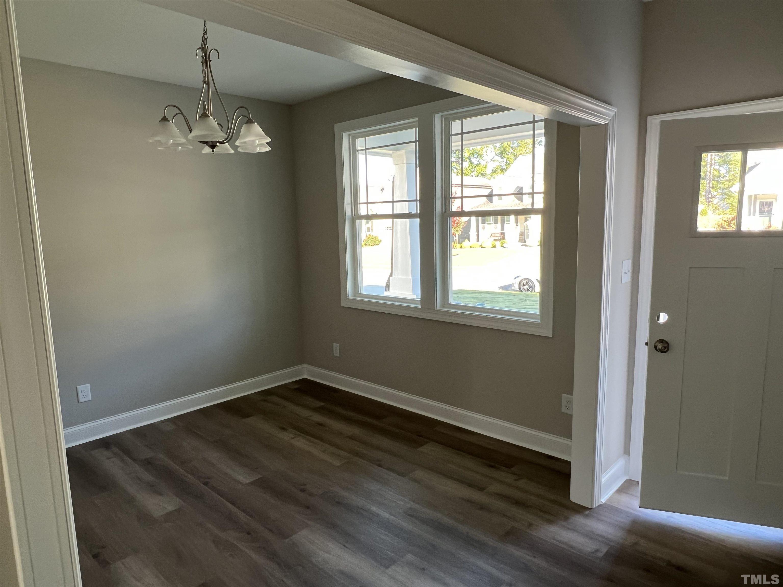 80 Unique Place Garner, NC 27529 - Photo 5 of 28 an empty room with wooden floor and windows