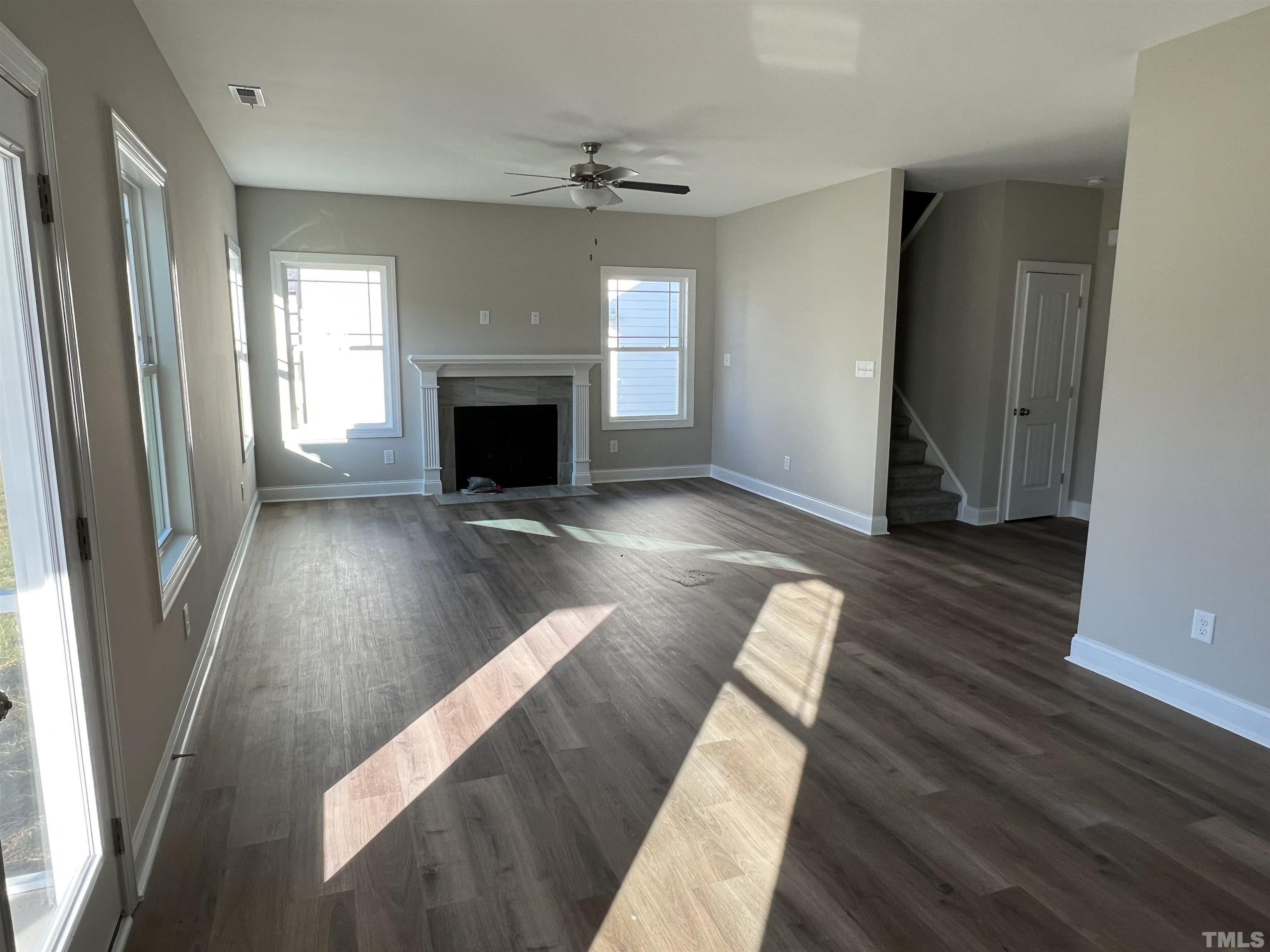 80 Unique Place Garner, NC 27529 - Photo 7 of 28 wooden floor in an empty room with a fireplace