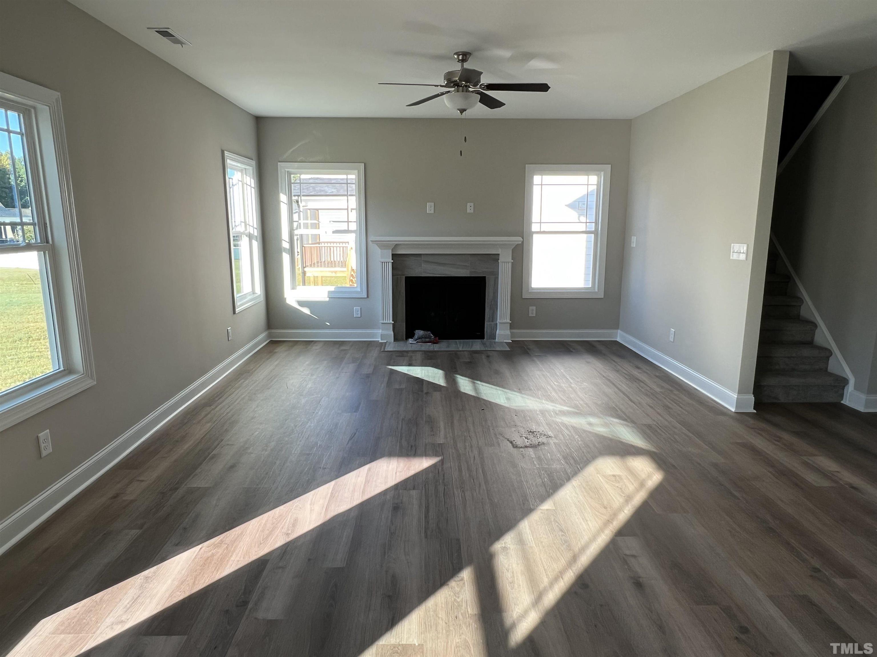 80 Unique Place Garner, NC 27529 - Photo 8 of 28 a view of a living room with wooden floor and a fireplace