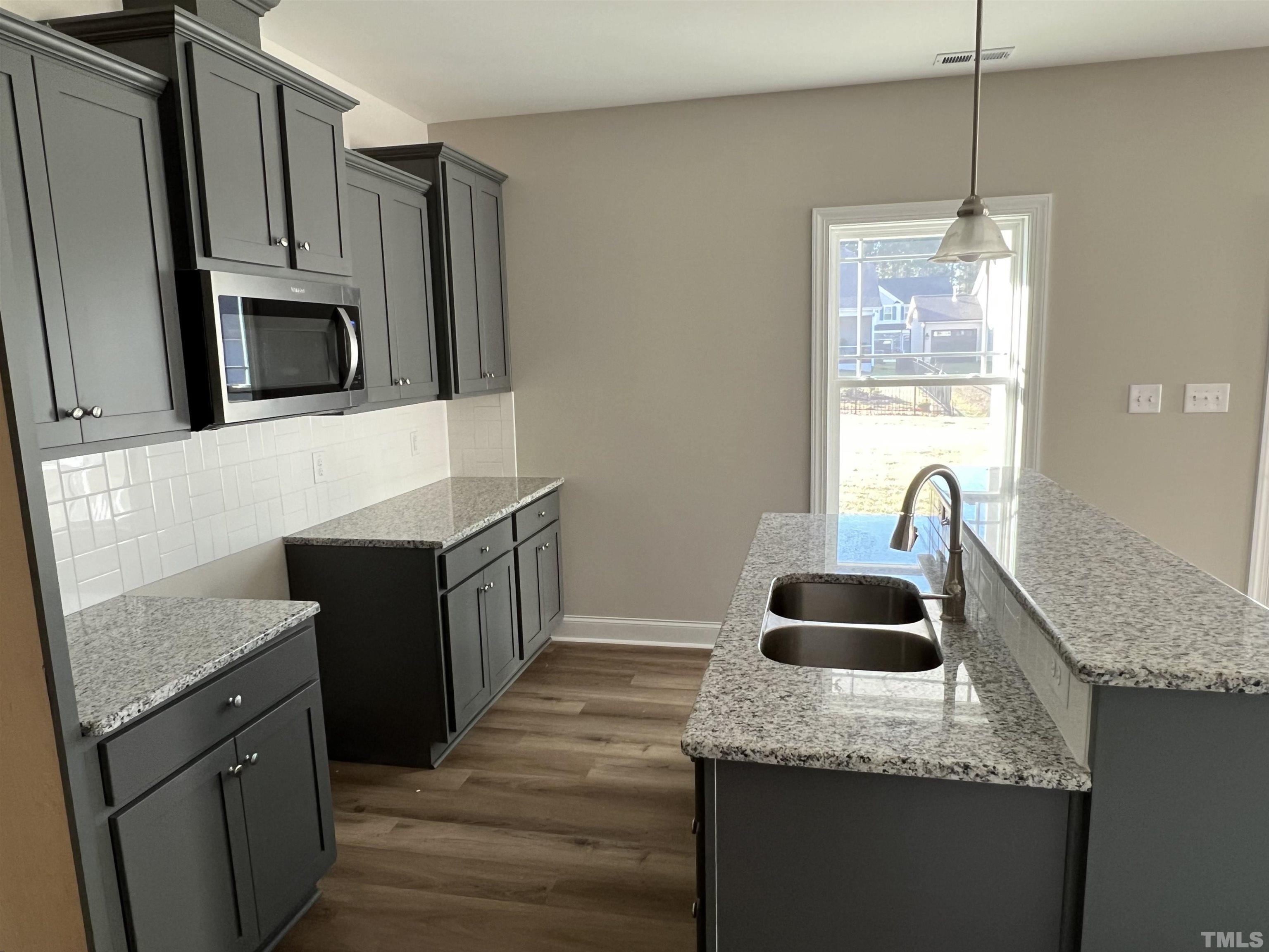 80 Unique Place Garner, NC 27529 - Photo 10 of 28 a kitchen with granite countertop a sink and a microwave